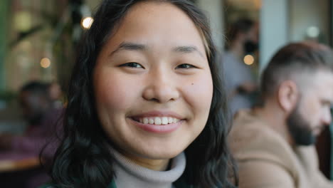 Portrait-of-Happy-Asian-Woman-in-Cafe